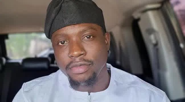 AIG Moshood Jimoh wearing a black cap inside a vehicle.