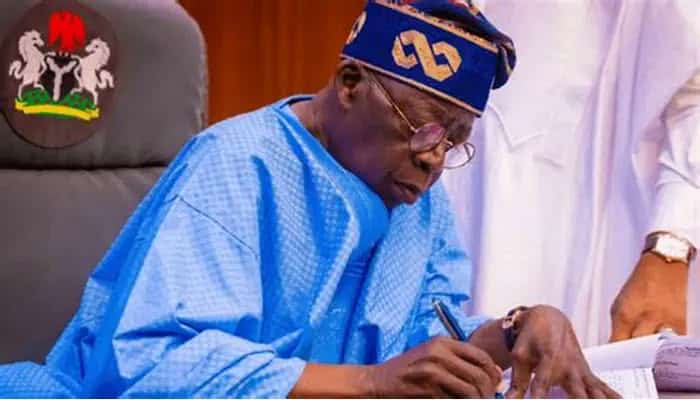Nigerian political leader signing documents at BMTV Nsukka studio.